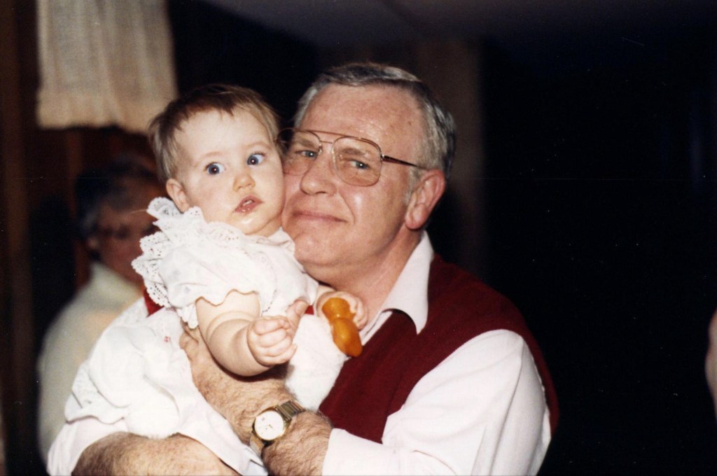 Grandpa holding baby granddaughter